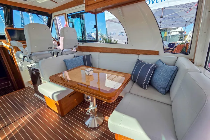 Slide: The Image of Luxurious interior of 2026 Back Cove 412 yacht with elegant seating and wooden table. - 23