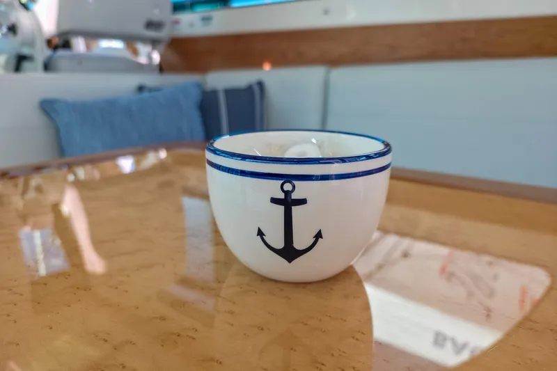 Slide: The Image of Ceramic cup with anchor design on Back Cove 412 yacht's wooden table, 2026 model. - 25