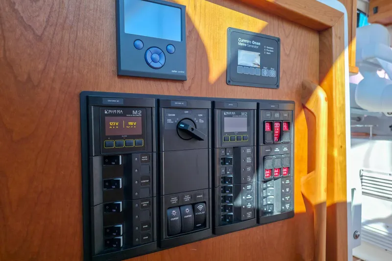 Slide: The Image of Electrical control panel on a 2026 Back Cove 412 boat, featuring various switches and displays. - 31