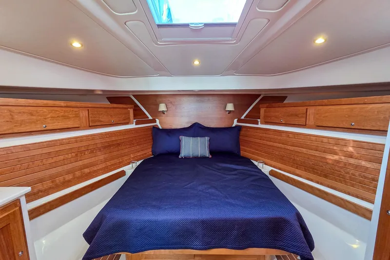 Slide: The Image of Luxurious cabin interior of 2026 Back Cove 412 yacht with wood paneling and cozy bedding. - 32