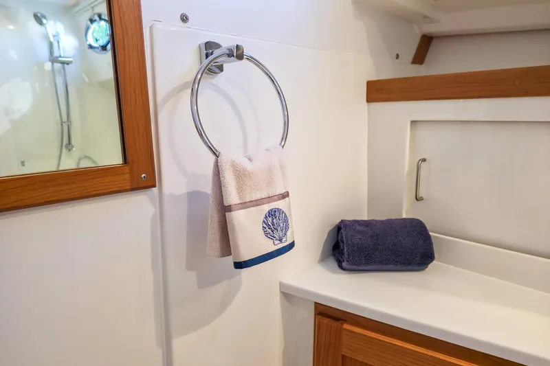 Slide: The Image of Bathroom interior of 2026 Back Cove 412 yacht with towels and wooden accents. - 39