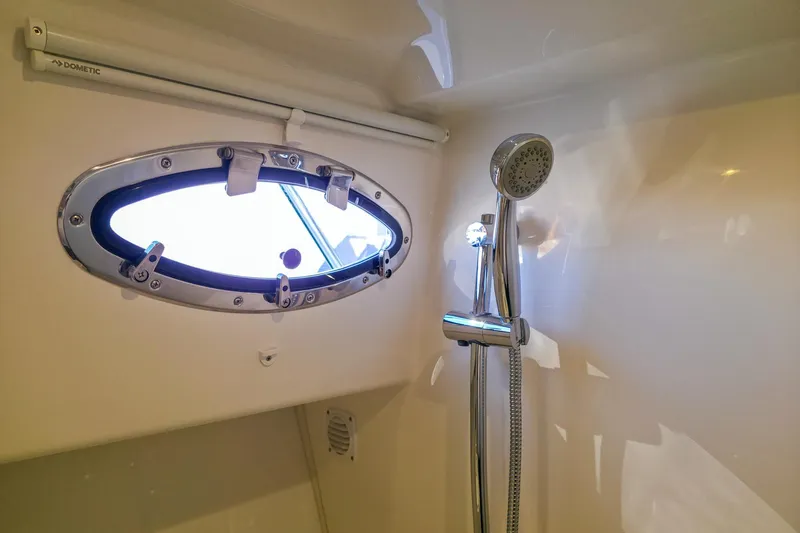 Slide: The Image of Shower area in 2026 Back Cove 412 yacht with oval window and chrome fixtures. - 42