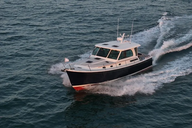 Slide: The Image of 2026 Back Cove 412 cruising on open water, showcasing sleek design and performance. - 6