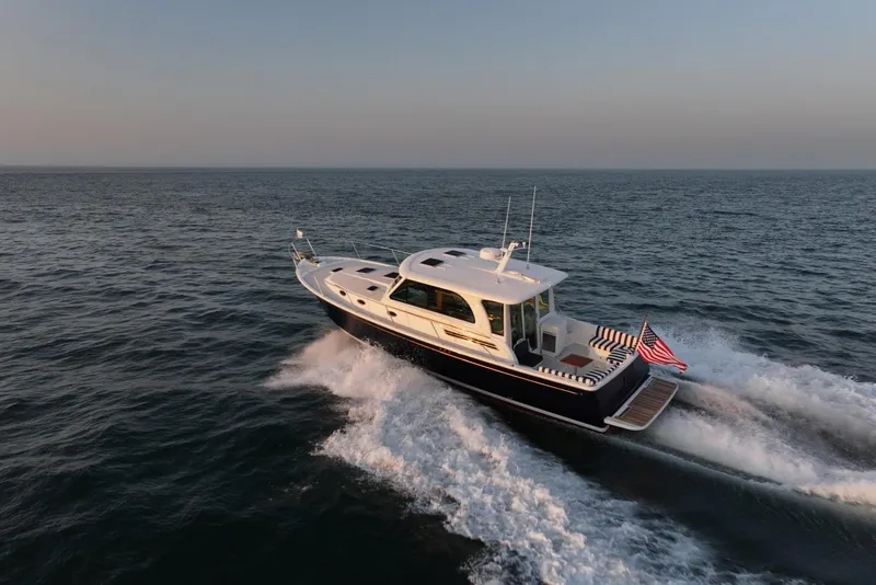 Slide: The Image of 2026 Back Cove 412 yacht cruising on open sea at sunset. - 7