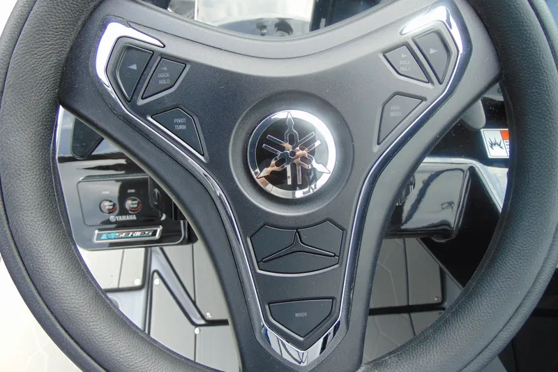 Slide: The Image of Steering wheel of 2026 Yamaha Boats 255XD with control buttons and logo. - 18