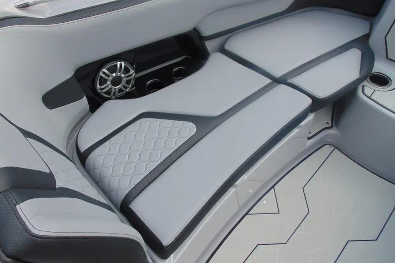 Slide: The Image of 2026 Yamaha Boats 255XD interior seating with speaker and cup holders. - 24