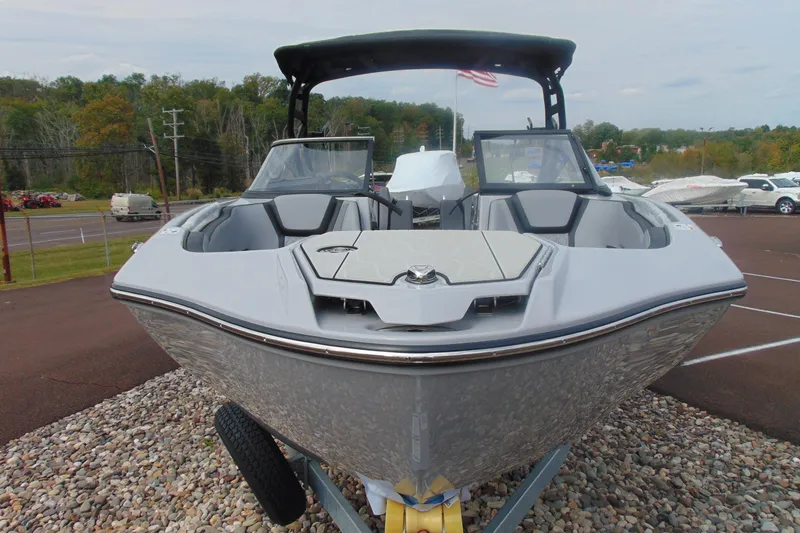 Slide: The Image of 2026 Yamaha Boats 255XD, sleek design, parked on gravel, outdoor setting. - 5