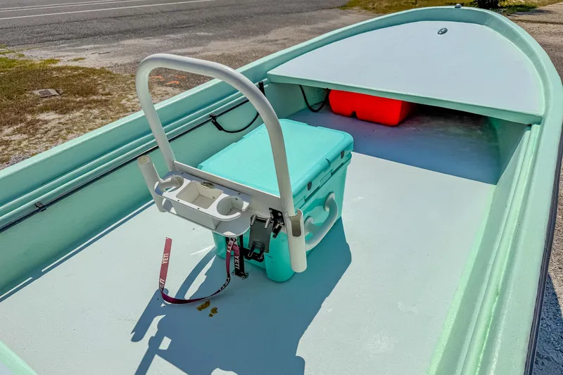 Slide: The Image of 15' Custom Tiller Skiff 2021 with cooler and rod holders on deck. - 13