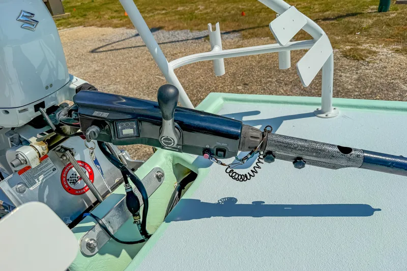 Slide: The Image of 15' Tiller Skiff 2021 with Suzuki outboard motor and control handle. - 18