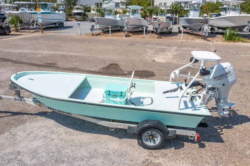 Slide: The Image of Custom 2021 15' Tiller Skiff with Suzuki outboard motor on trailer. - 2