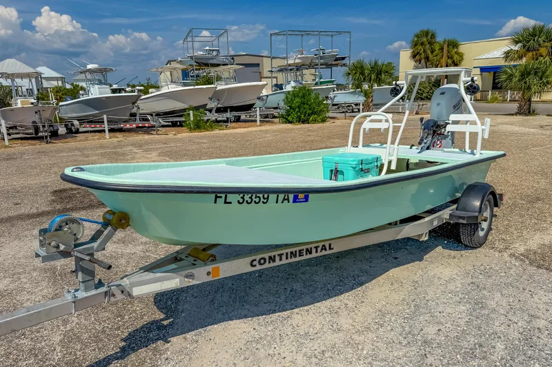 Slide: The Image of 15' Custom Tiller Skiff 2021 on trailer, parked outdoors under clear sky. - 9