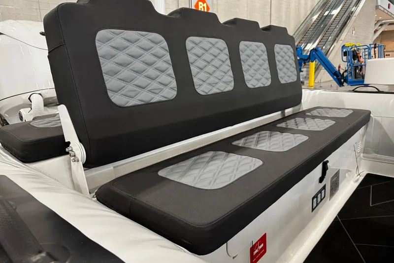 Slide: The Image of 2026 Highfield Sport 800 boat seating with quilted gray and black upholstery. - 12