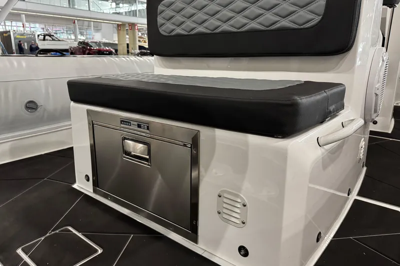 Slide: The Image of 2026 Highfield Sport 800 boat interior with cushioned seating and built-in storage compartment. - 8