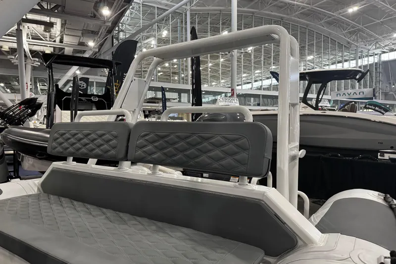 Slide: The Image of 2026 Highfield Patrol 540 boat interior with quilted seating at a showroom. - 11