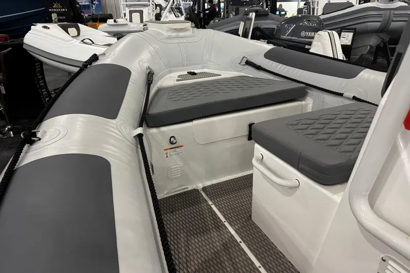 Slide: The Image of 2026 Highfield Patrol 540 boat dashboard with steering wheel and control panel. - 6