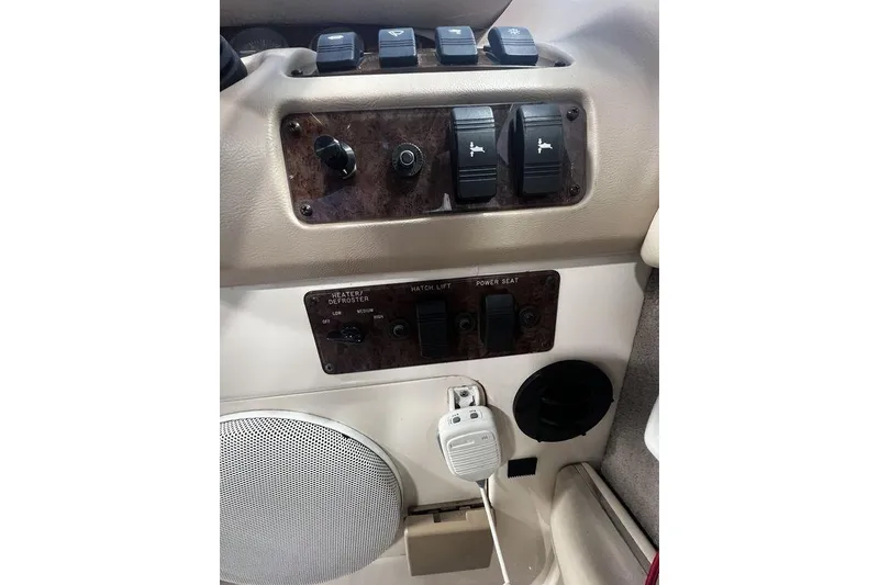 Slide: The Image of Control panel of a 1994 Sea Ray 220 boat with switches and speaker. - 7