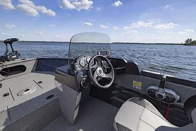 Slide: The Image of Manufacturer Provided Image: 2026 Crestliner 1650 Kodiak boat interior with steering wheel, dashboard, and lake view. - 19