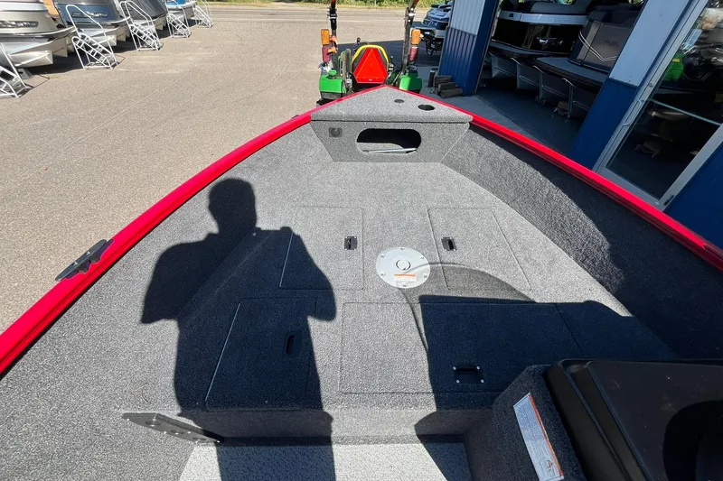 Slide: The Image of 2026 Crestliner 1650 Kodiak boat interior with red trim and storage compartments. - 6