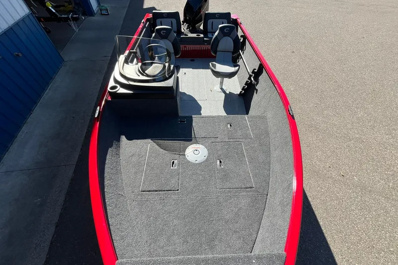 Slide: The Image of 2026 Crestliner 1650 Kodiak boat with red exterior and spacious interior layout. - 7