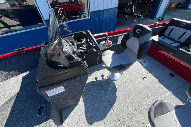 Slide: The Image of 2026 Crestliner 1650 Kodiak boat interior with steering console and seating. - 9