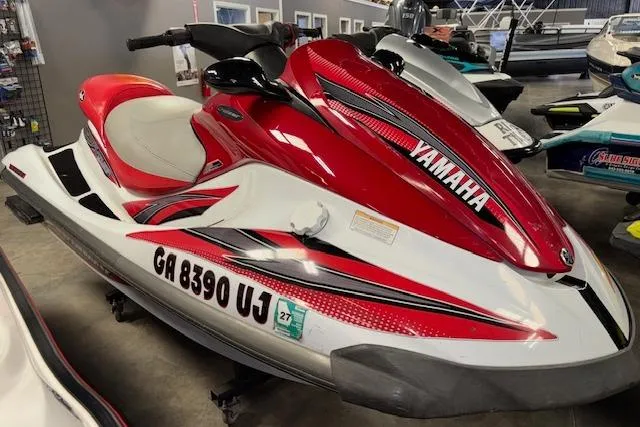 The Image of 2002 Yamaha WaveRunner FX Cruiser in showroom, red and white design, side view. - 1