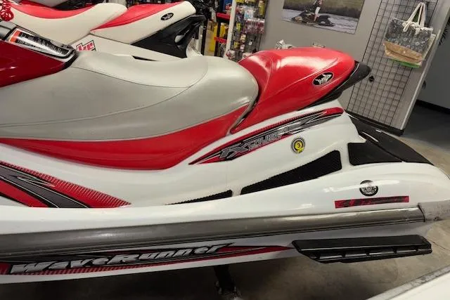 Slide: The Image of 2002 Yamaha WaveRunner FX Cruiser in red and white, displayed indoors. - 9
