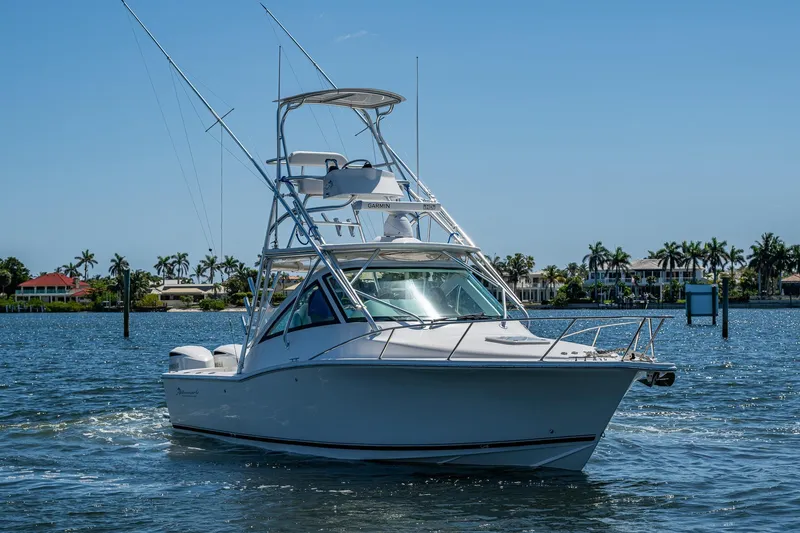 Slide: The Image of 2018 Albemarle 290 Express Fisherman boat cruising on a sunny day near palm trees. - 16