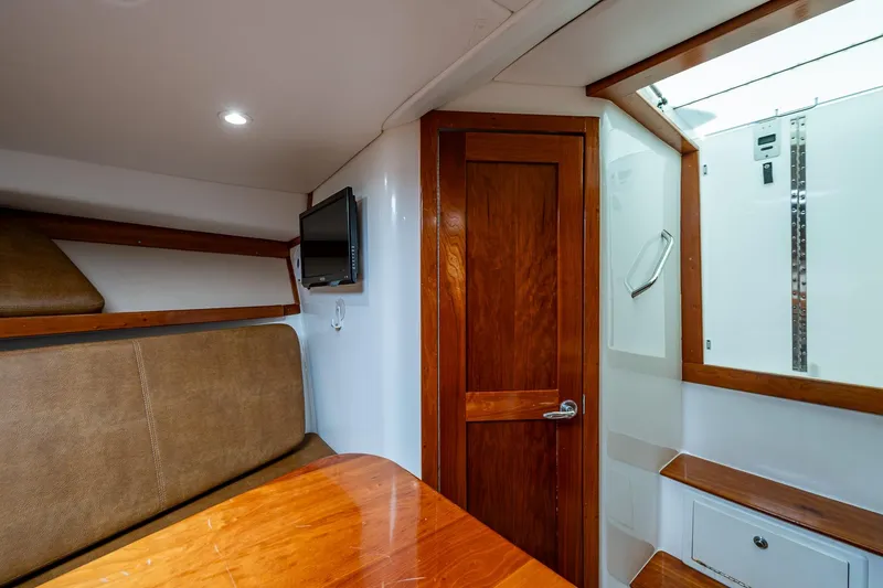 Slide: The Image of Interior of 2018 Albemarle 290 Express Fisherman with wood accents and seating area. - 22