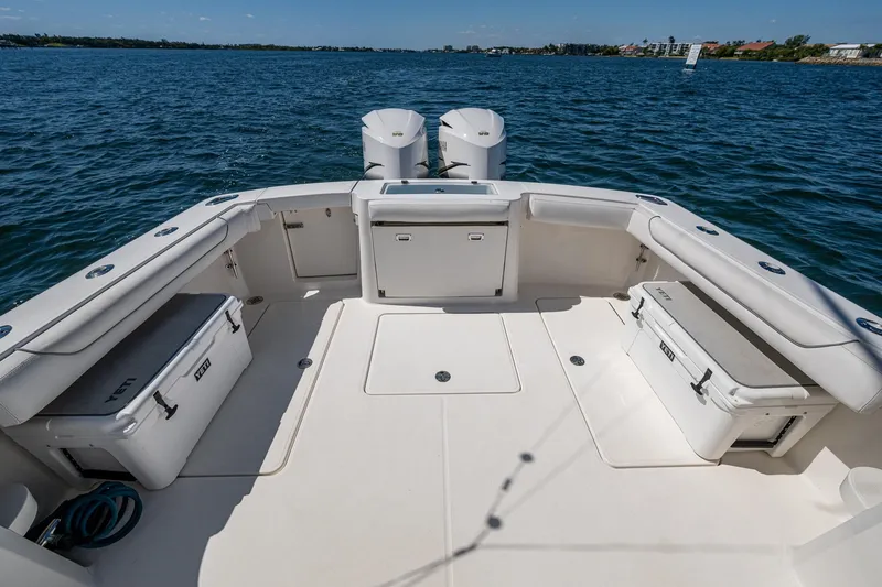 Slide: The Image of 2018 Albemarle 290 Express Fisherman boat deck with seating and storage, on open water. - 31