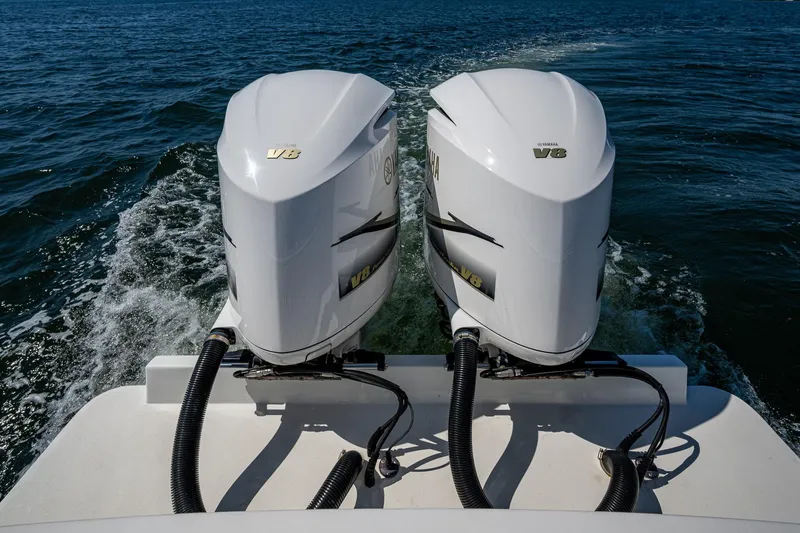 Slide: The Image of Twin Yamaha V8 engines on a 2018 Albemarle 290 Express Fisherman boat in open water. - 36