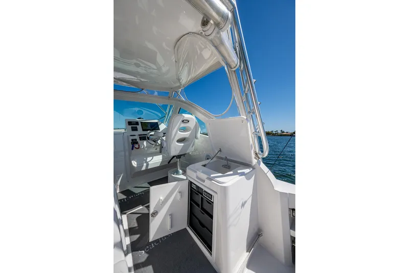 Slide: The Image of 2018 Albemarle 290 Express Fisherman boat interior with helm and storage compartments. - 39