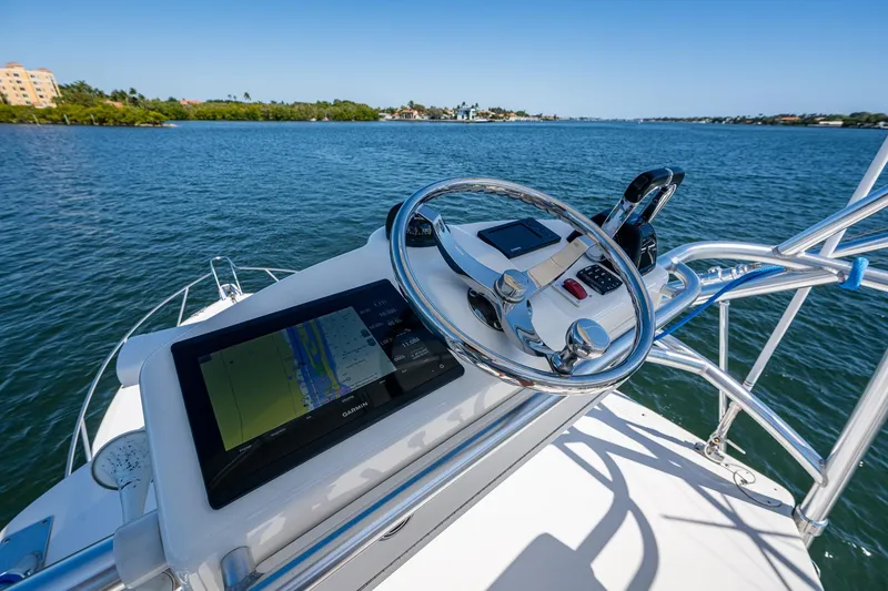 Slide: The Image of 2018 Albemarle 290 Express Fisherman helm with navigation system on calm waters. - 43