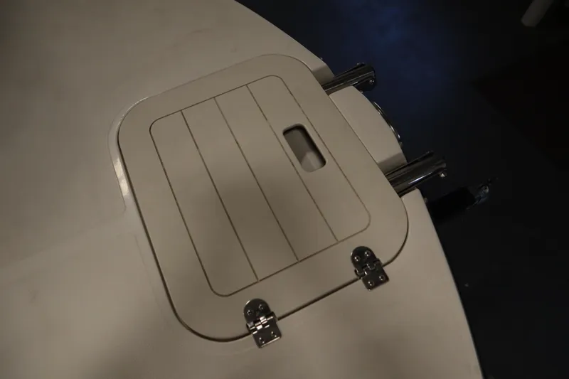 Slide: The Image of Hatch on 2017 Starcraft 221 STARSTEP boat, featuring metal hinges and handle. - 11