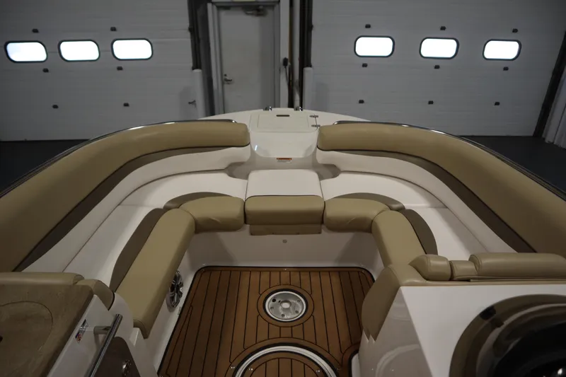 Slide: The Image of 2017 Starcraft 221 STARSTEP boat interior with tan seating and wood flooring. - 13