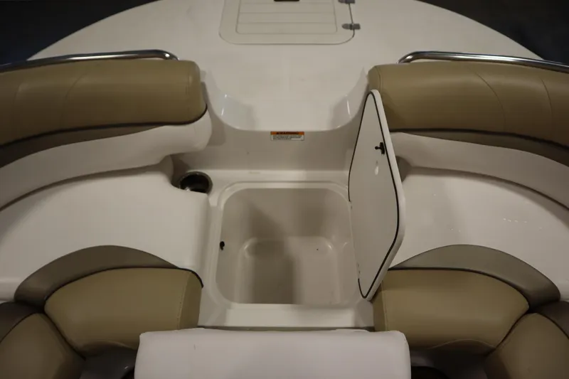 Slide: The Image of 2017 Starcraft 221 STARSTEP boat interior with open storage compartment and cushioned seating. - 15