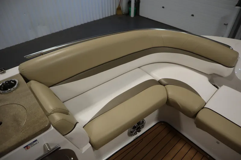 Slide: The Image of 2017 Starcraft 221 STARSTEP boat interior with beige and white cushioned seating. - 16