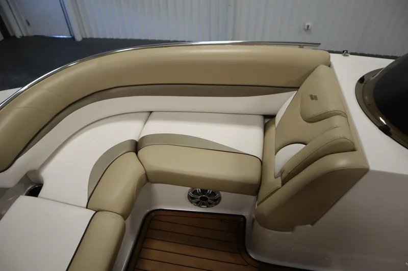 Slide: The Image of 2017 Starcraft 221 STARSTEP boat interior with beige and white cushioned seating. - 18