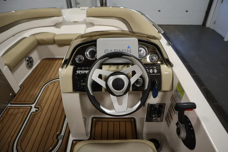 Slide: The Image of 2017 Starcraft 221 STARSTEP boat interior with steering wheel and Garmin navigation system. - 21
