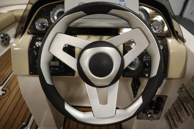 Slide: The Image of Steering wheel of 2017 Starcraft 221 STARSTEP boat with dashboard controls. - 22