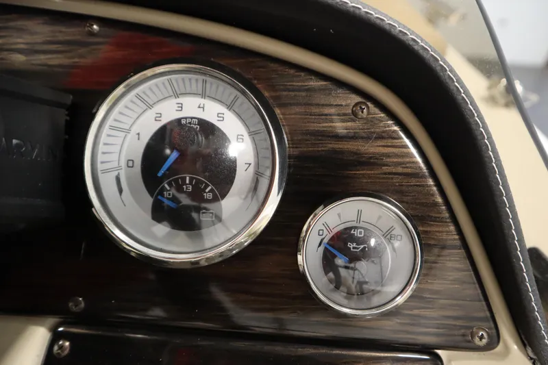Slide: The Image of Dashboard gauges of 2017 Starcraft 221 STARSTEP boat, featuring RPM and oil pressure indicators. - 24