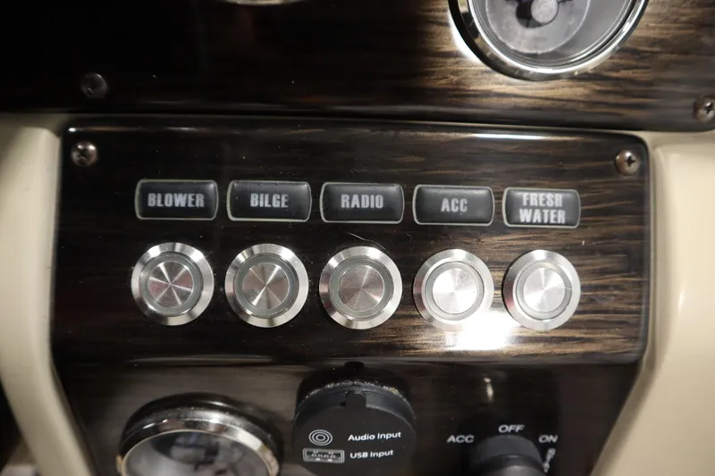 Slide: The Image of Control panel of 2017 Starcraft 221 STARSTEP boat with labeled buttons and knobs. - 29