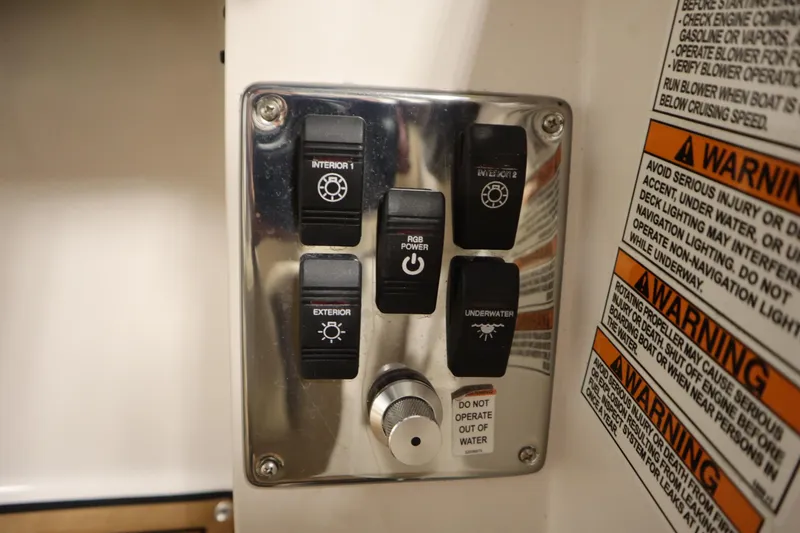 Slide: The Image of Control panel of 2017 Starcraft 221 STARSTEP boat with various lighting switches and warnings. - 31