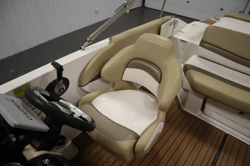 Slide: The Image of 2017 Starcraft 221 STARSTEP boat interior with beige seating and Garmin navigation system. - 34