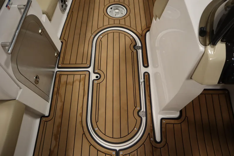 Slide: The Image of 2017 Starcraft 221 STARSTEP boat interior with sleek wooden flooring and stainless steel accents. - 36