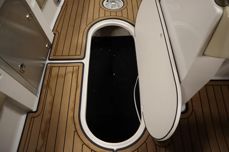 Slide: The Image of 2017 Starcraft 221 STARSTEP boat interior with open storage compartment and wood-patterned flooring. - 37