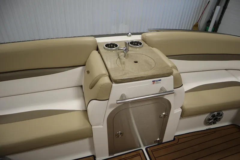 Slide: The Image of 2017 Starcraft 221 STARSTEP boat interior with beige seating and built-in sink. - 38