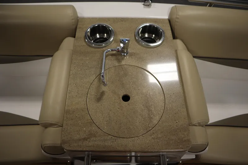 Slide: The Image of 2017 Starcraft 221 STARSTEP boat interior with beige seating and built-in cup holders. - 40