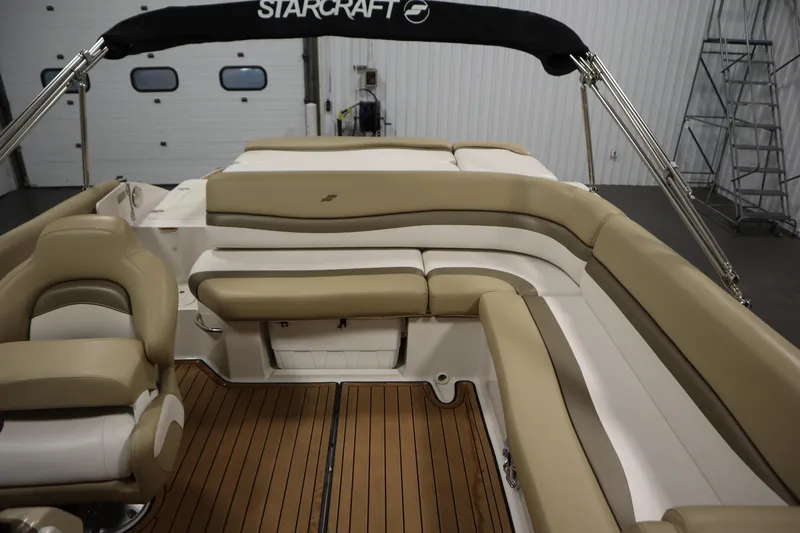 Slide: The Image of 2017 Starcraft 221 Starstep boat interior with beige seating and wood flooring. - 42