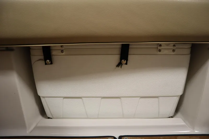 Slide: The Image of 2017 Starcraft 221 STARSTEP boat storage compartment with secured white cooler. - 43