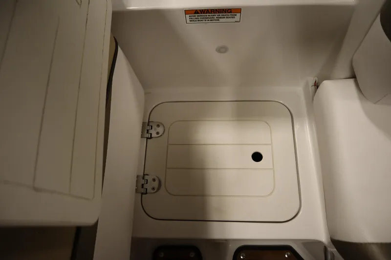 Slide: The Image of 2017 Starcraft 221 STARSTEP boat storage compartment with warning label. - 47